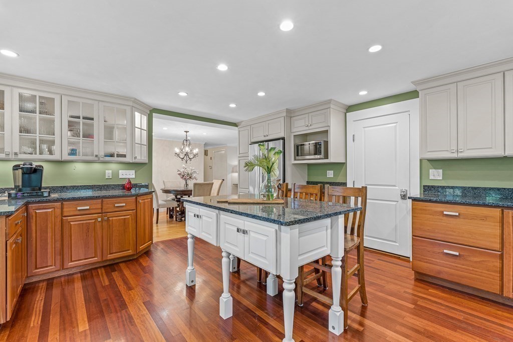 98 Parker Road Wellesley, MA 02482 - Photo 13 of 30 a kitchen with granite countertop wooden floors and wooden cabinets