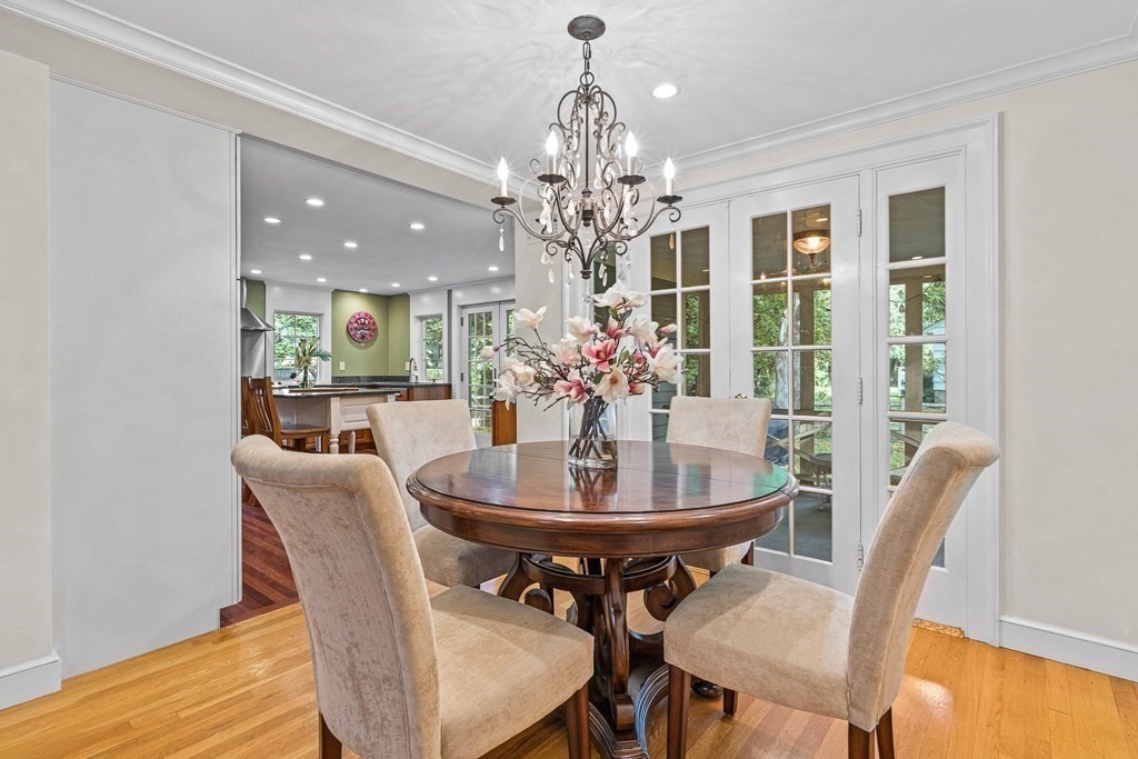 98 Parker Road Wellesley, MA 02482 - Photo 7 of 30 a dining room with furniture a chandelier and wooden floor