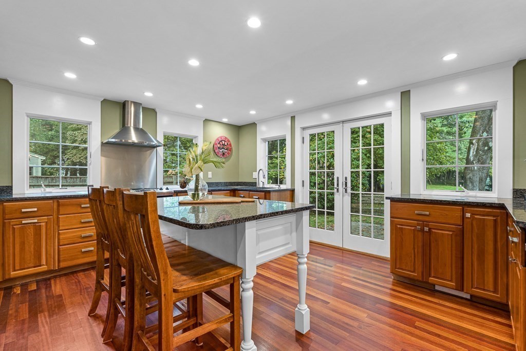 98 Parker Road Wellesley, MA 02482 - Photo 9 of 30 a kitchen with stainless steel appliances granite countertop wooden floor window and dining table