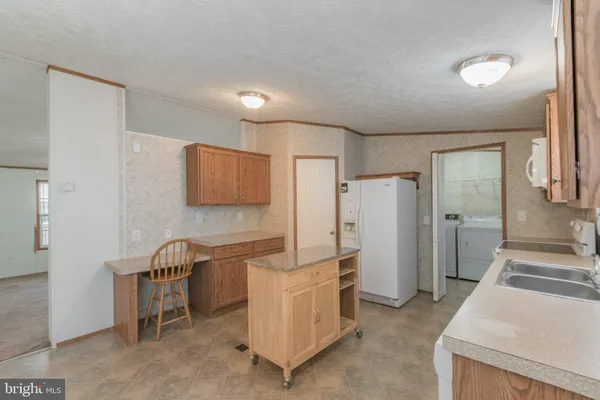 a kitchen with a sink cabinets and window
