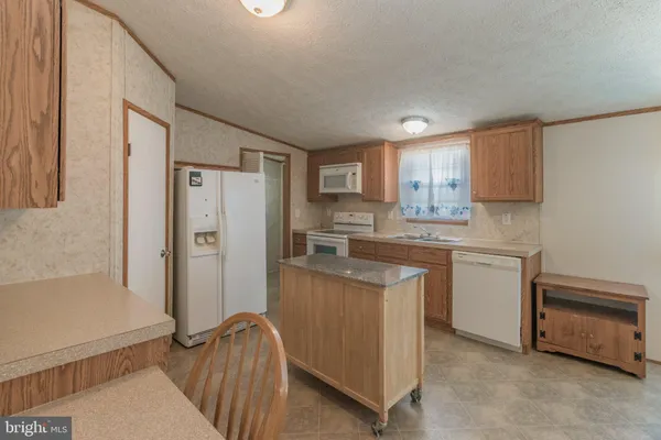 a kitchen with refrigerator and cabinets