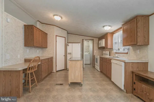 a kitchen with a refrigerator and window