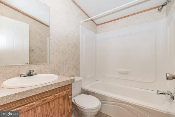 a view of an empty room with a window and cabinet