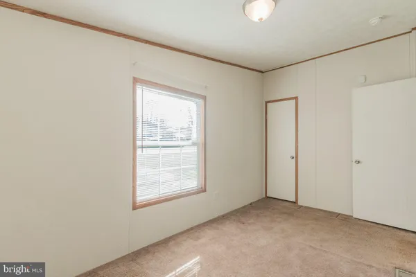 a view of a hallway with wooden shelves