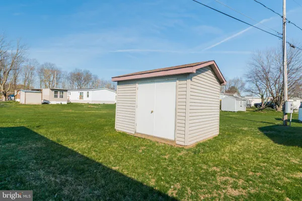 an aerial view of a house with a yard and lake view