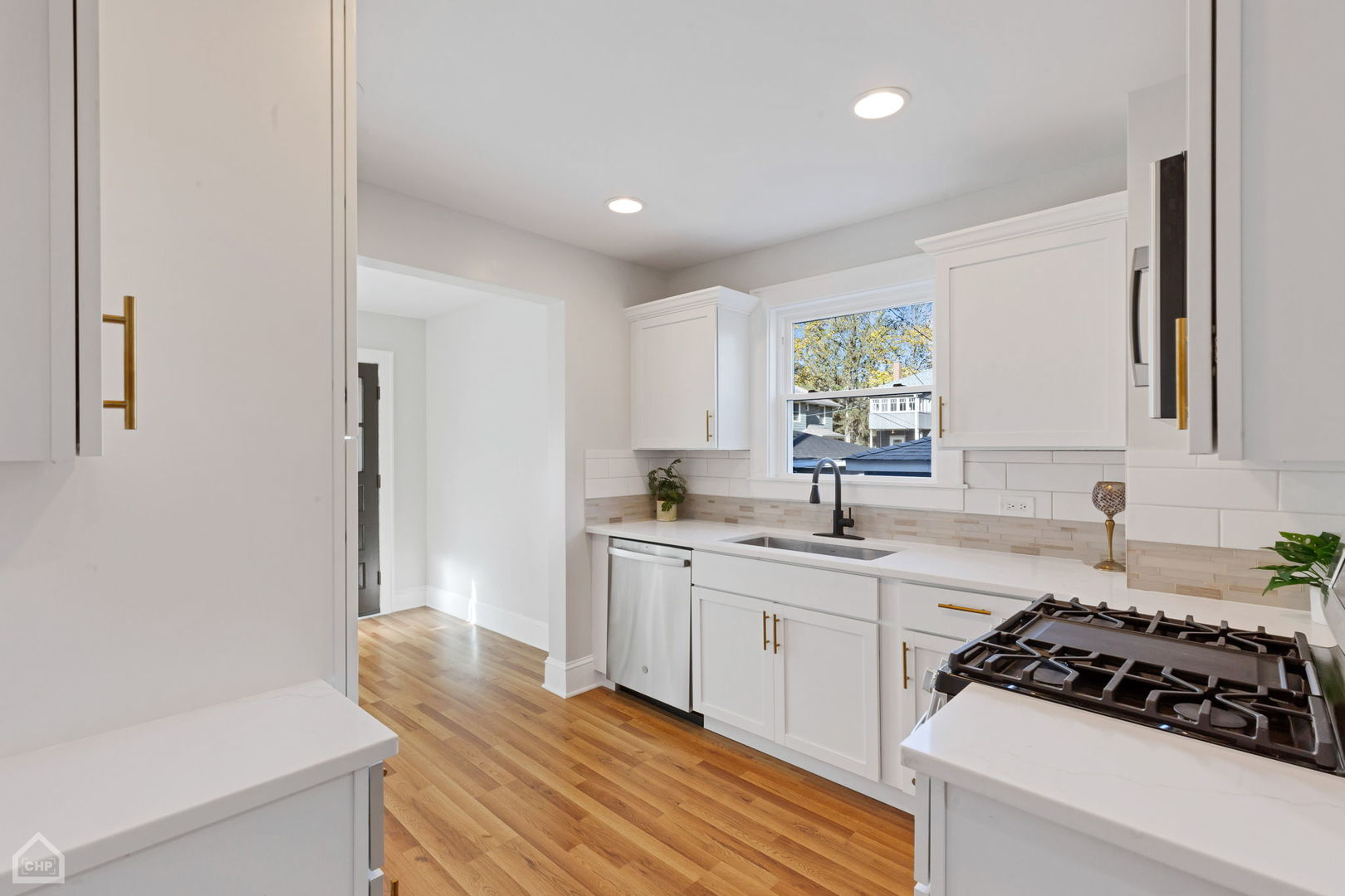30 North Delaplaine Road Riverside, IL 60546 - Photo 5 of 21 a kitchen with a sink stove and cabinets