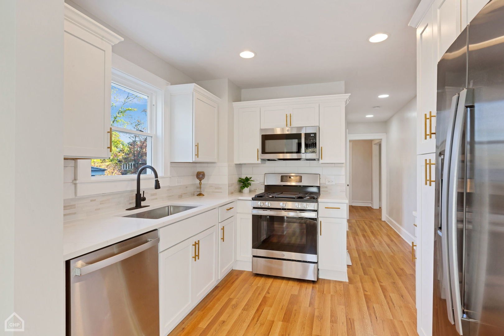 30 North Delaplaine Road Riverside, IL 60546 - Photo 6 of 21 a kitchen with a sink wooden floor and stainless steel appliances