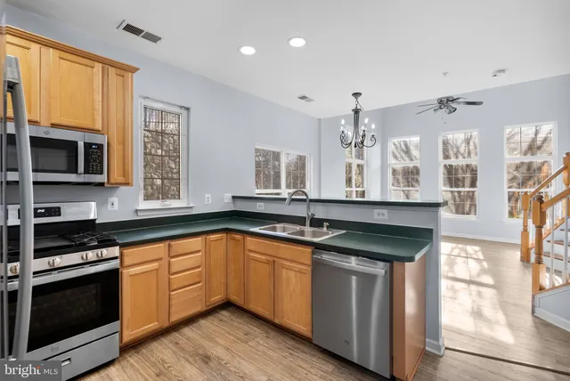 a kitchen with a sink stove and microwave
