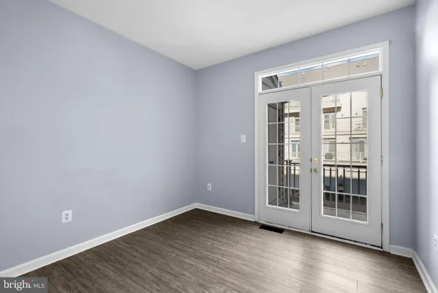 a view of wooden floor and windows in a room