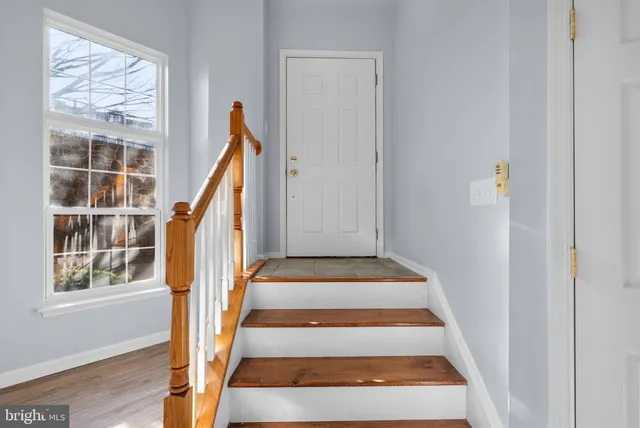 a view of staircase with wooden floor and a window