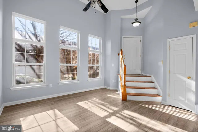 a view of an entryway with wooden floor and door