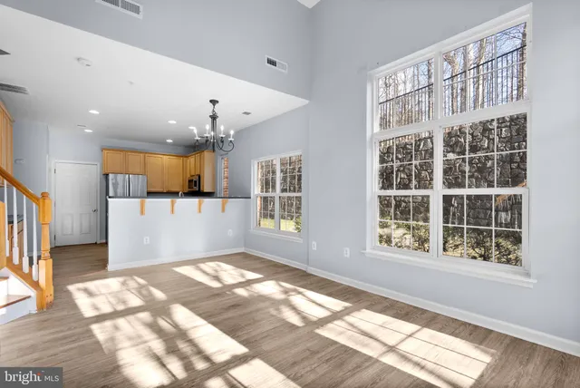 a view of livingroom and kitchen with wooden floor