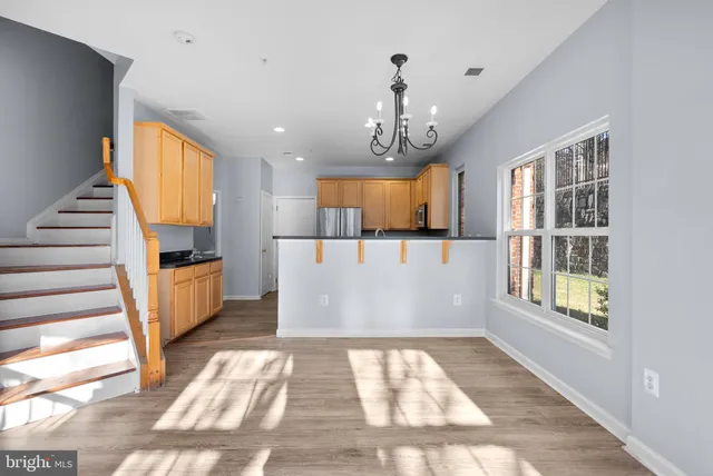 a view of kitchen and hall with wooden floor and window