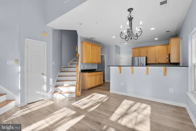 a view of a room with wooden floor and staircase
