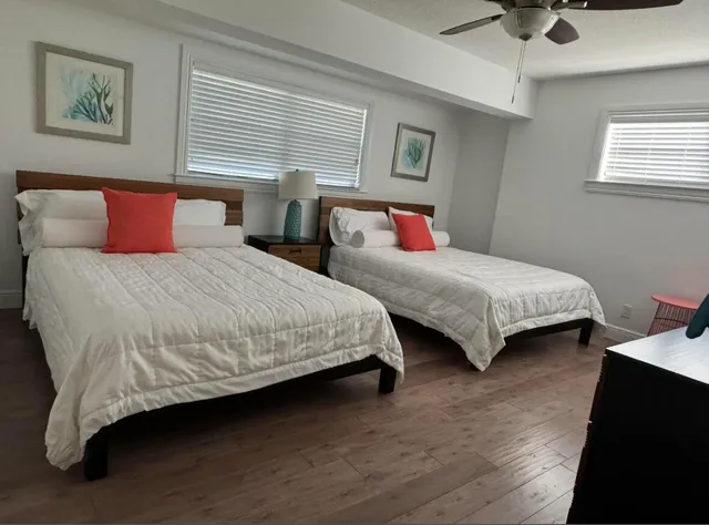 a bedroom with two beds and a chandelier