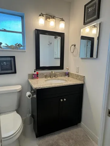 a bathroom with a sink vanity and mirror