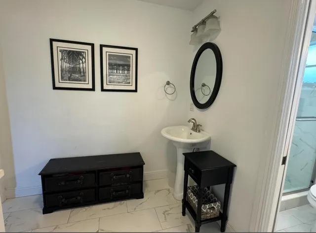 a bathroom with a toilet a sink and a mirror