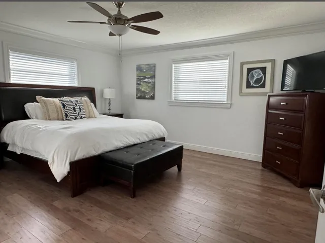 a bedroom with a bed and a tv