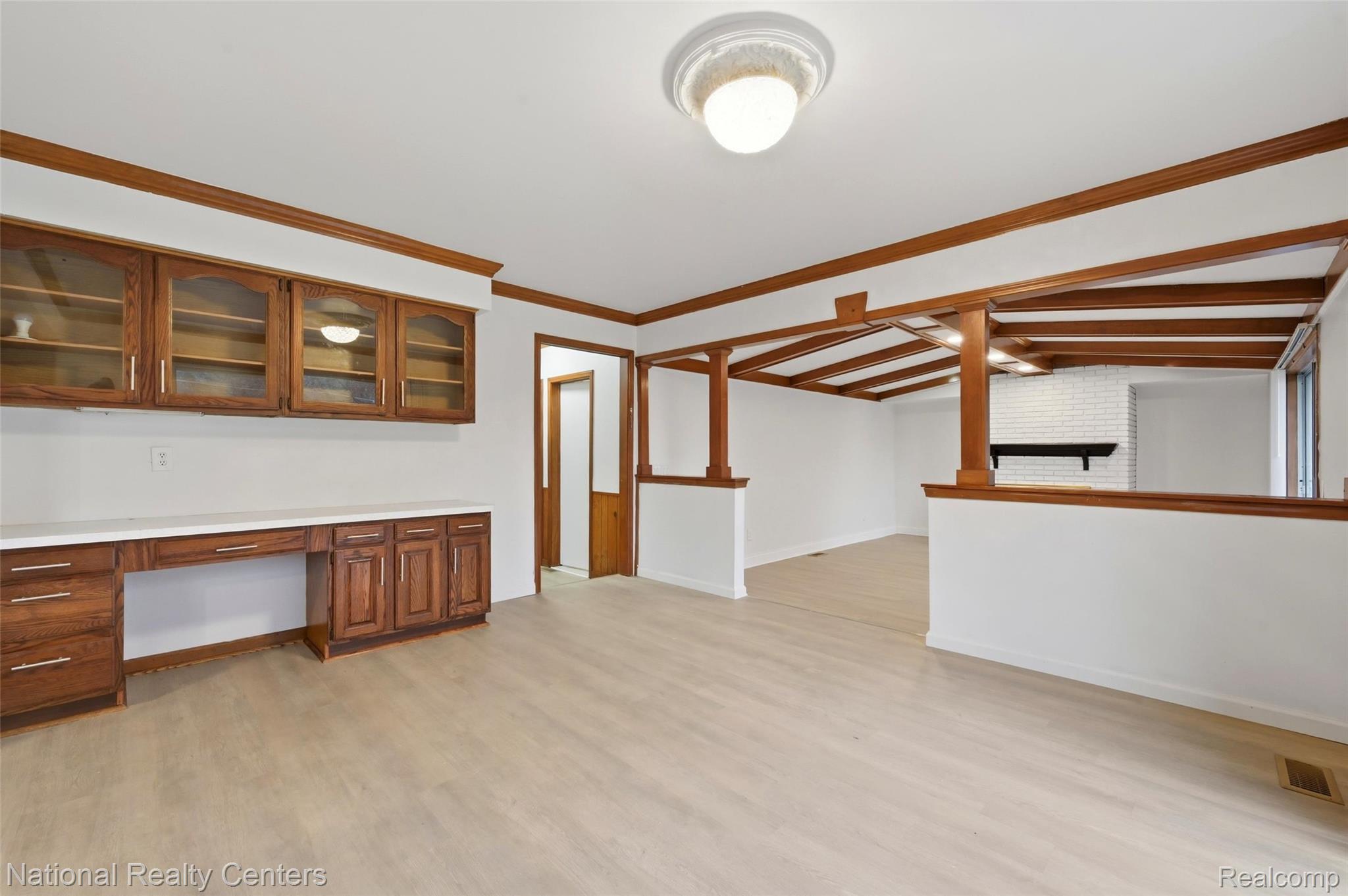 37625 Ryan Road Sterling Heights, MI 48310 - Photo 15 of 30 Unfurnished office with built in desk, crown molding, and light wood-type flooring