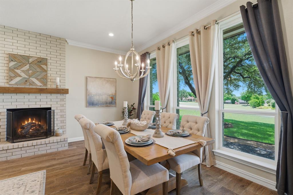 10390 Ridgecrest Street Frisco, TX 75033 - Photo 10 of 40 a dining room with furniture a fireplace and large windows