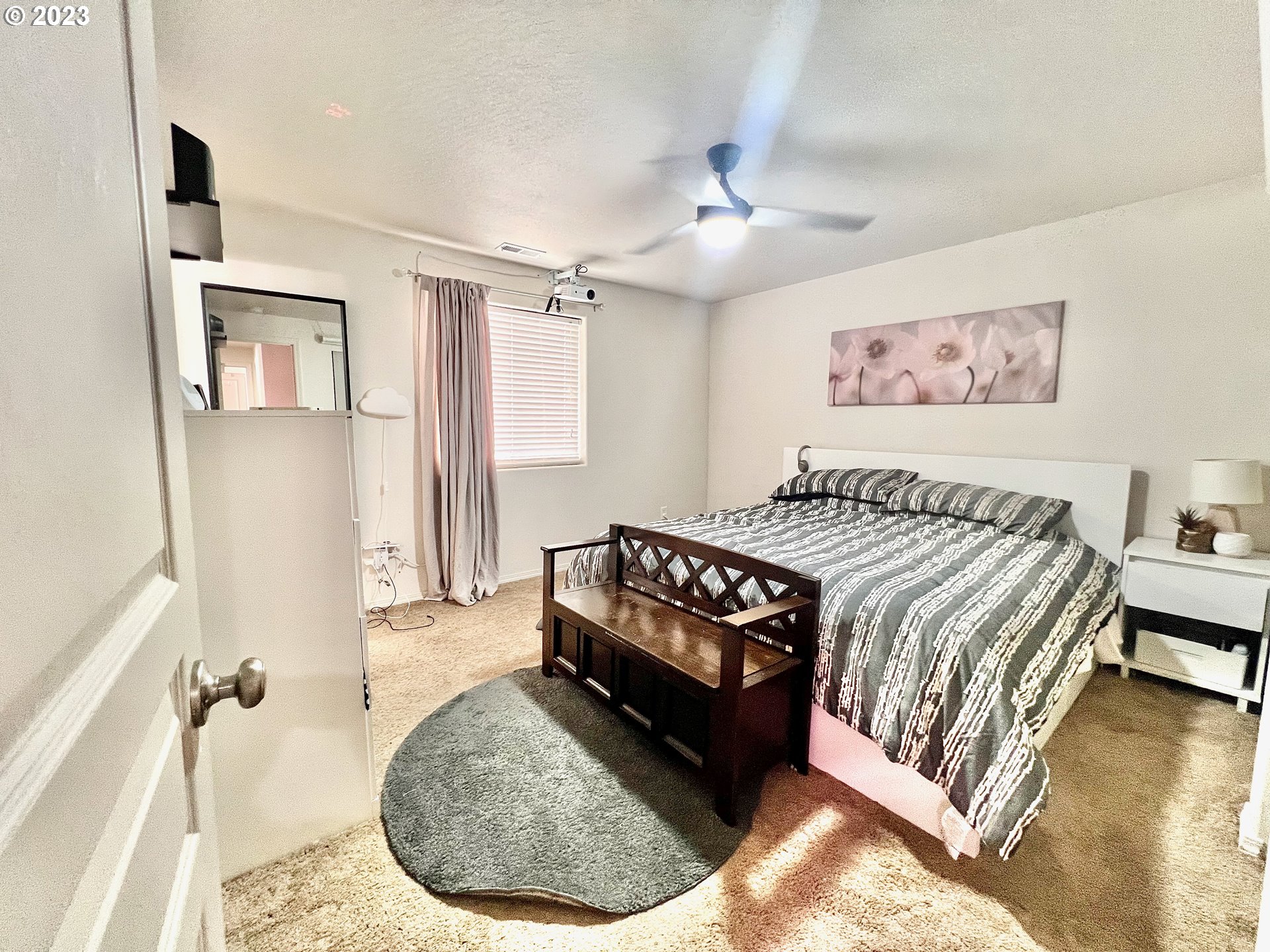 4686 Rocky Road Springfield, OR 97478 - Photo 14 of 25 a bed sitting in a bedroom next to a window and a chandelier