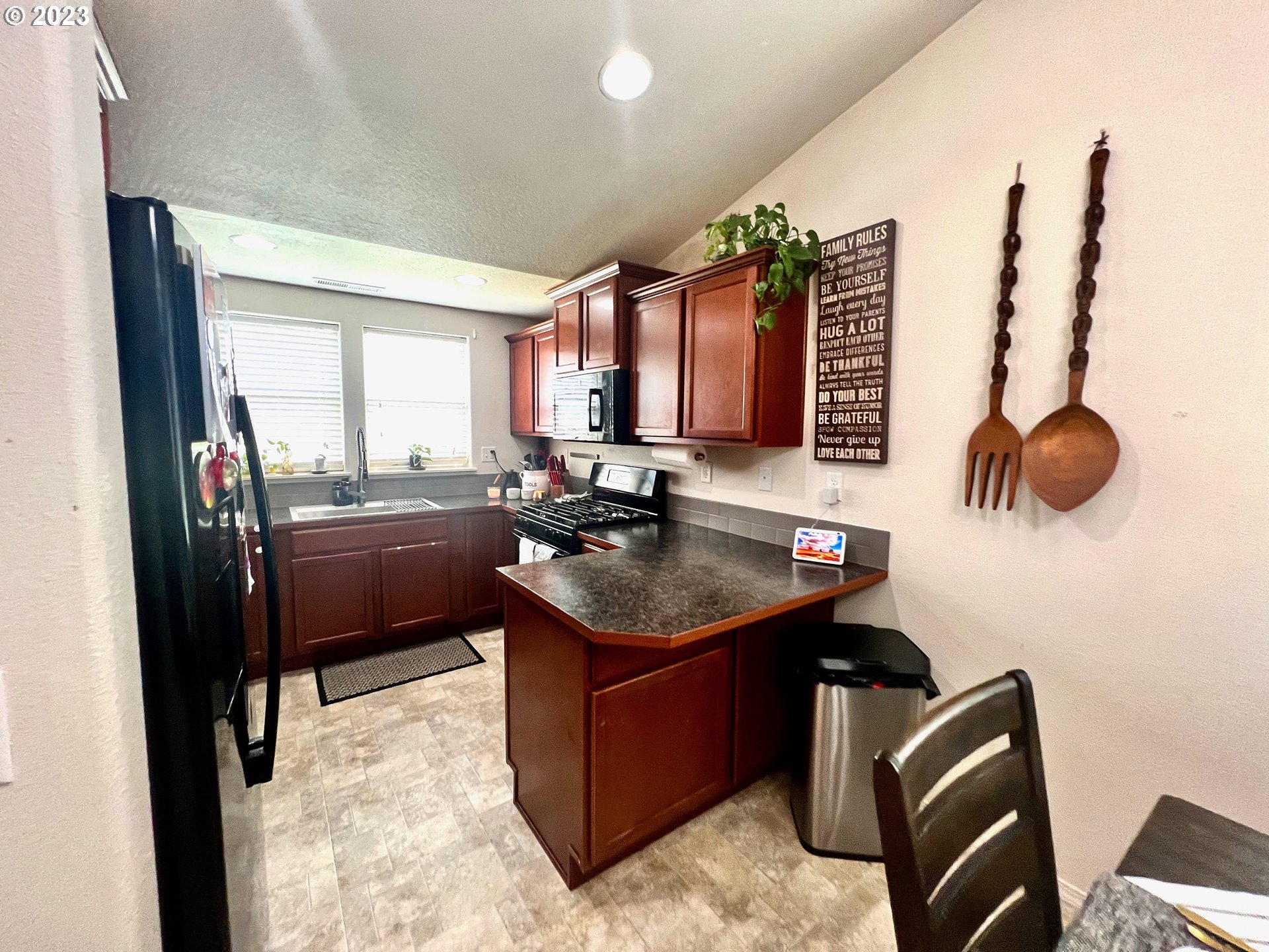 4686 Rocky Road Springfield, OR 97478 - Photo 2 of 25 a kitchen with a refrigerator stove and sink