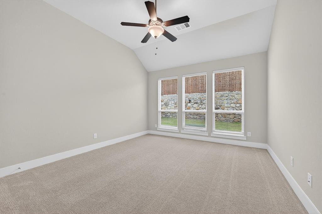 4123 Windy Point Court Oak Point, TX 75068 - Photo 26 of 29 Vaulted ceiling room featuring light-toned carpet, white baseboards, and a three-pane window with horizontal blinds