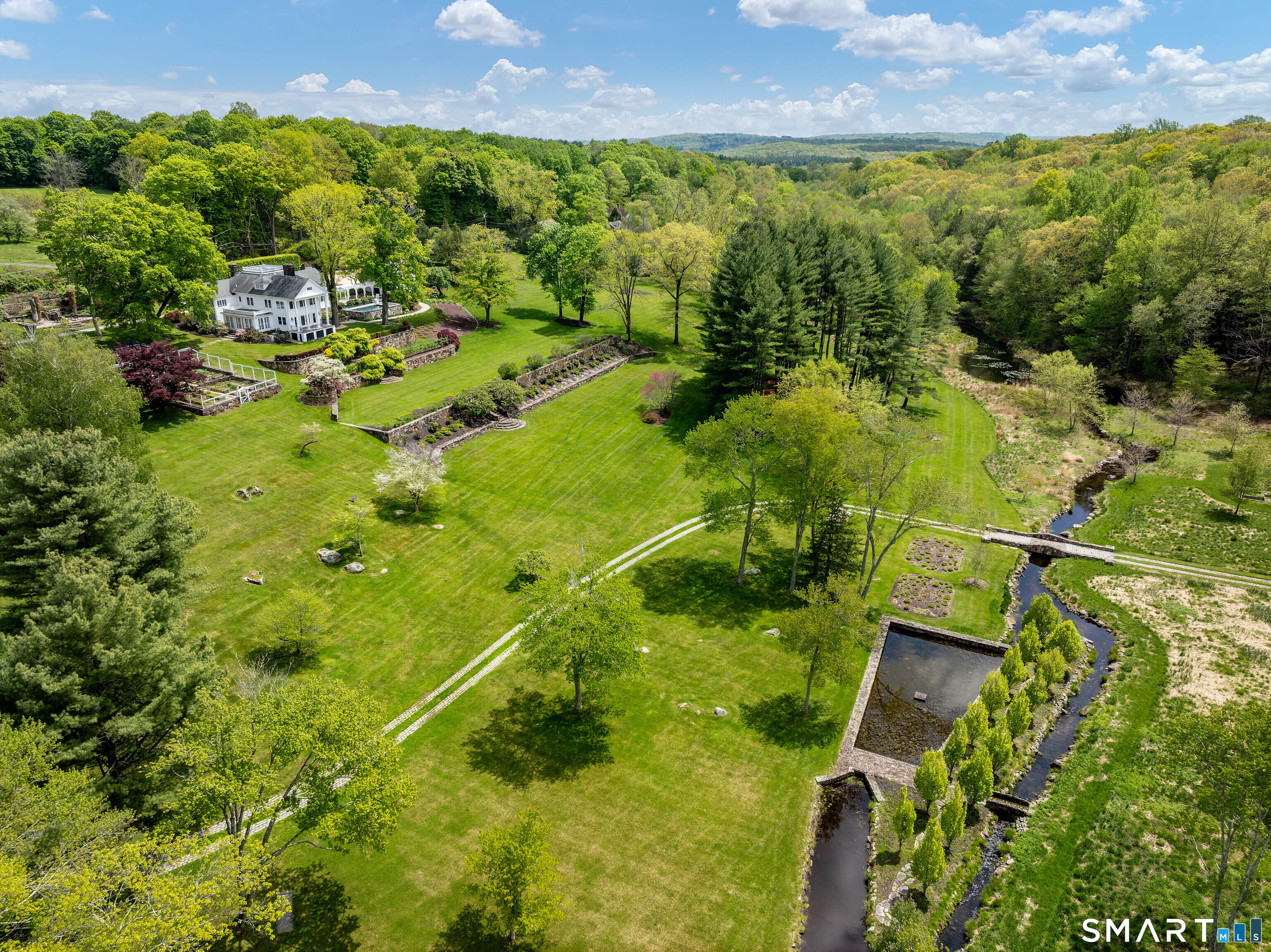 155 Long Ridge Road Danbury, CT 06810 - Photo 8 of 40 The grounds unfold across rolling lawns, water, and woodland, giving the estate both beauty and real breadth.