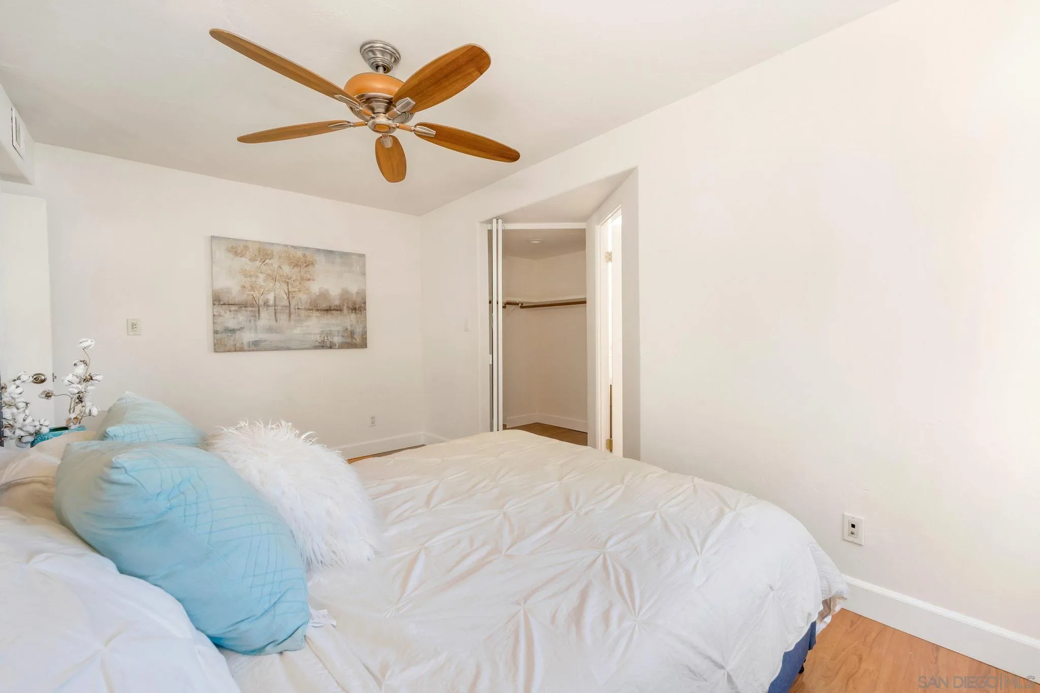 914 Agate Street, Unit E San Diego, CA 92109 - Photo 12 of 24 a bedroom with a bed and a ceiling fan