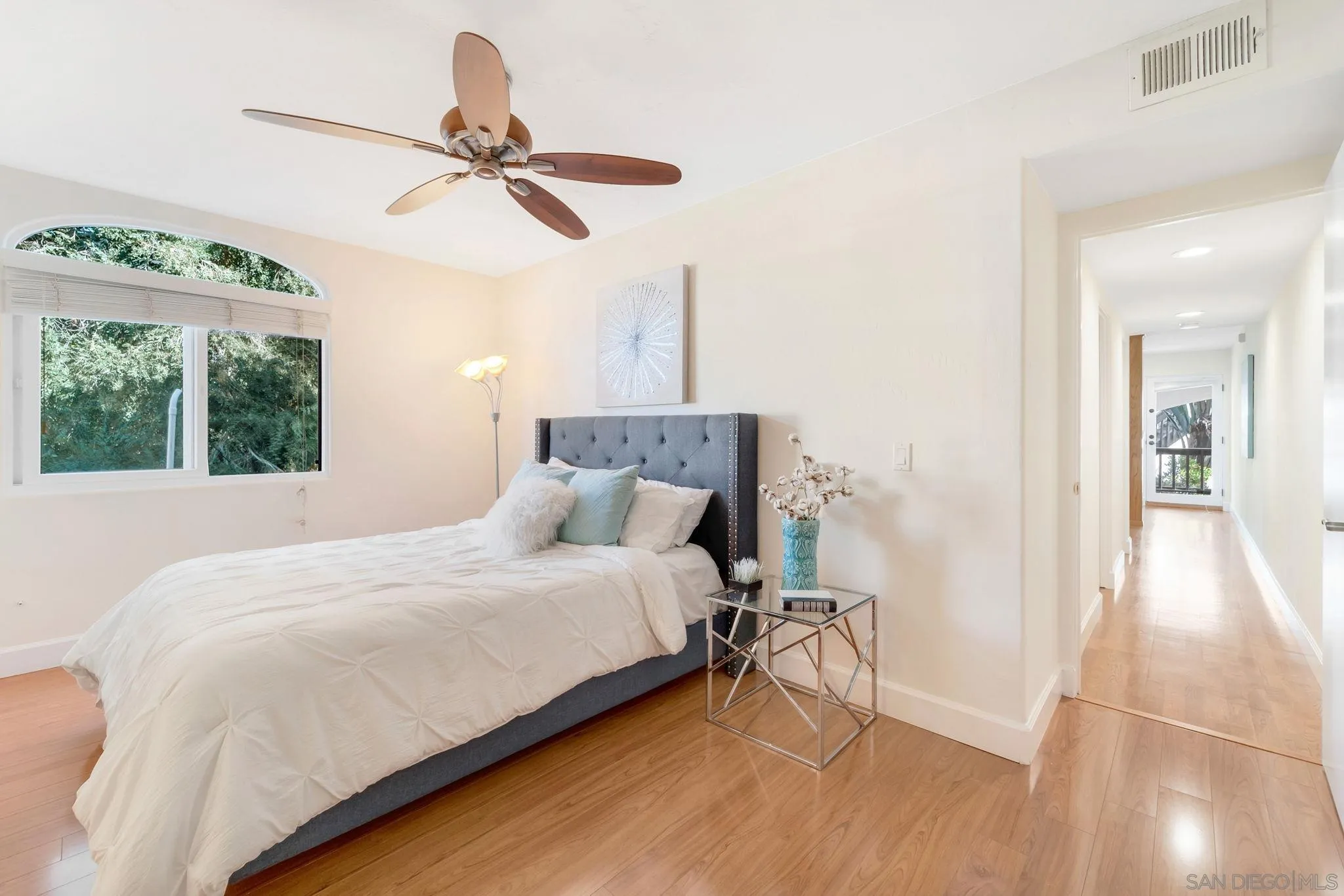 914 Agate Street, Unit E San Diego, CA 92109 - Photo 13 of 24 a bedroom with a bed and a window