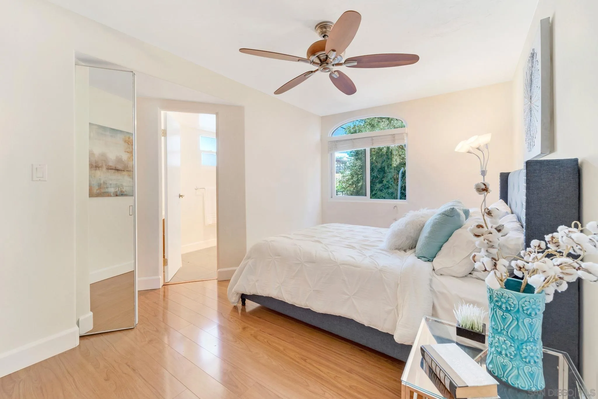 914 Agate Street, Unit E San Diego, CA 92109 - Photo 14 of 24 a bedroom with a bed chandelier and a window