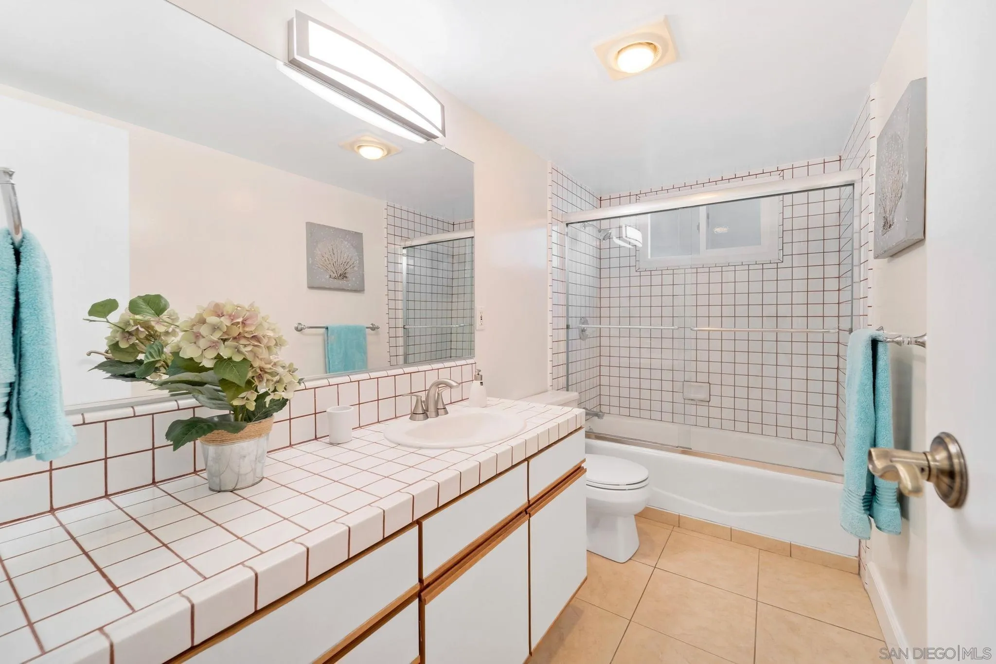 914 Agate Street, Unit E San Diego, CA 92109 - Photo 16 of 24 a bathroom with a sink a toilet and shower