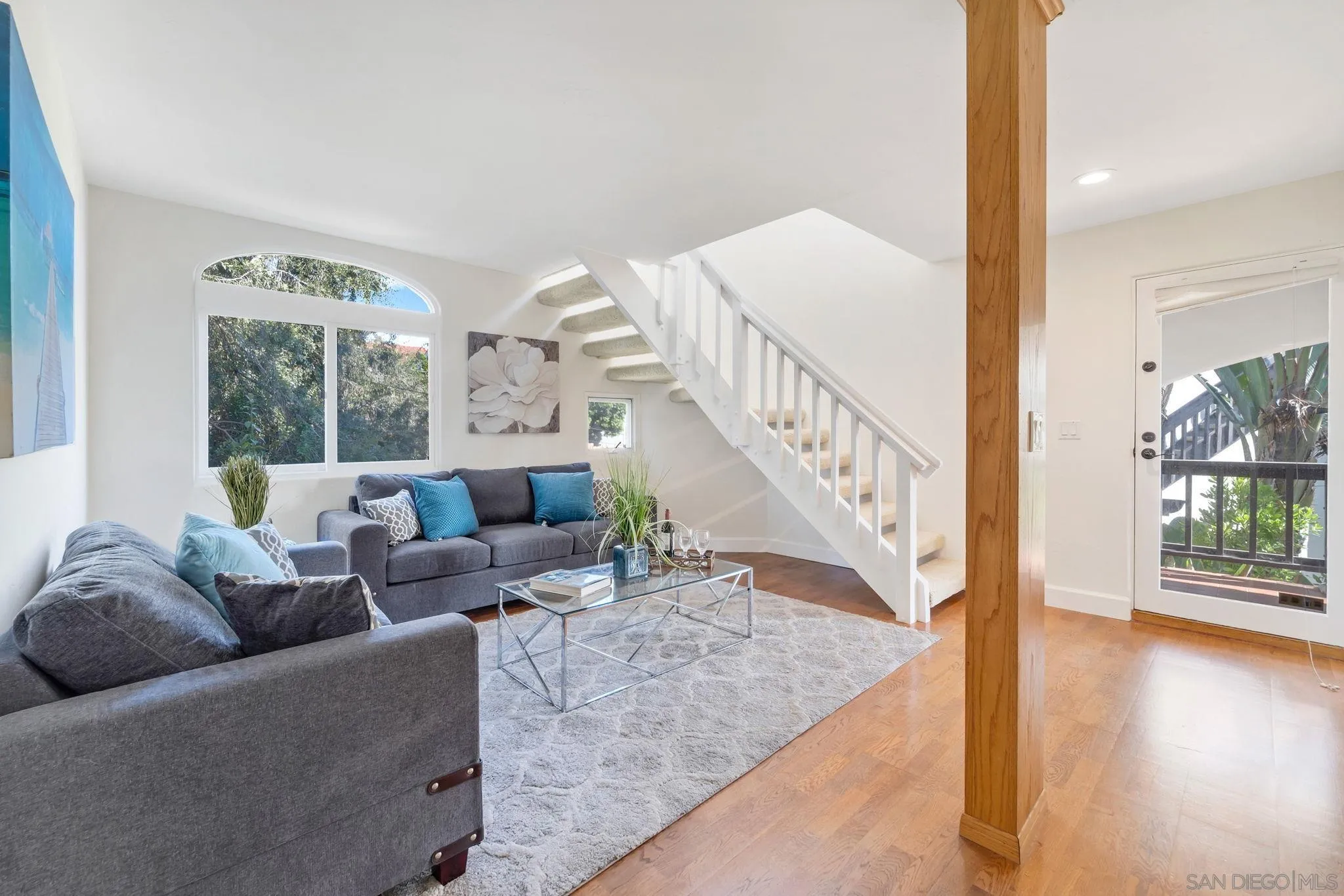 914 Agate Street, Unit E San Diego, CA 92109 - Photo 19 of 24 a living room with furniture and wooden floor next to a window