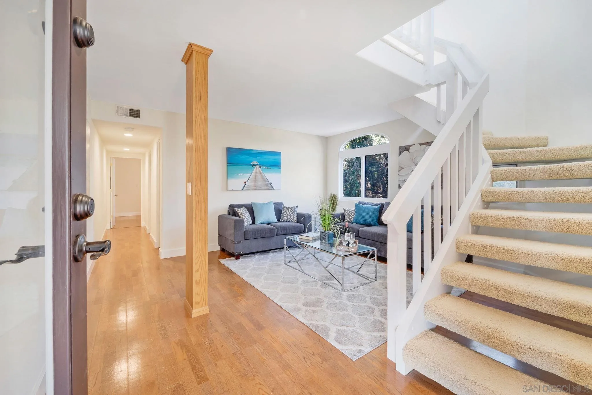 914 Agate Street, Unit E San Diego, CA 92109 - Photo 20 of 24 a living room with furniture and a table