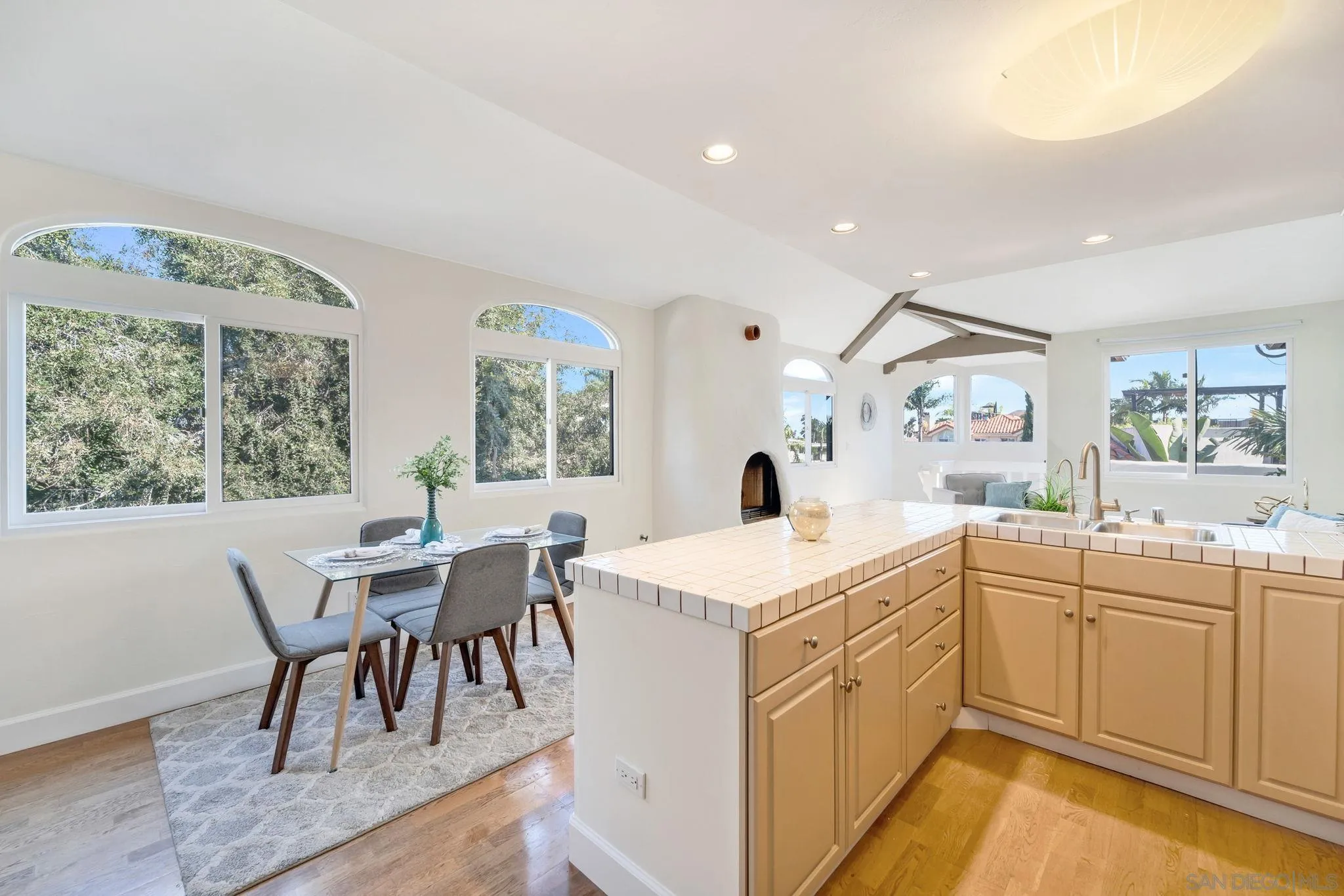 914 Agate Street, Unit E San Diego, CA 92109 - Photo 4 of 24 a kitchen with a sink dining table chairs and view living room