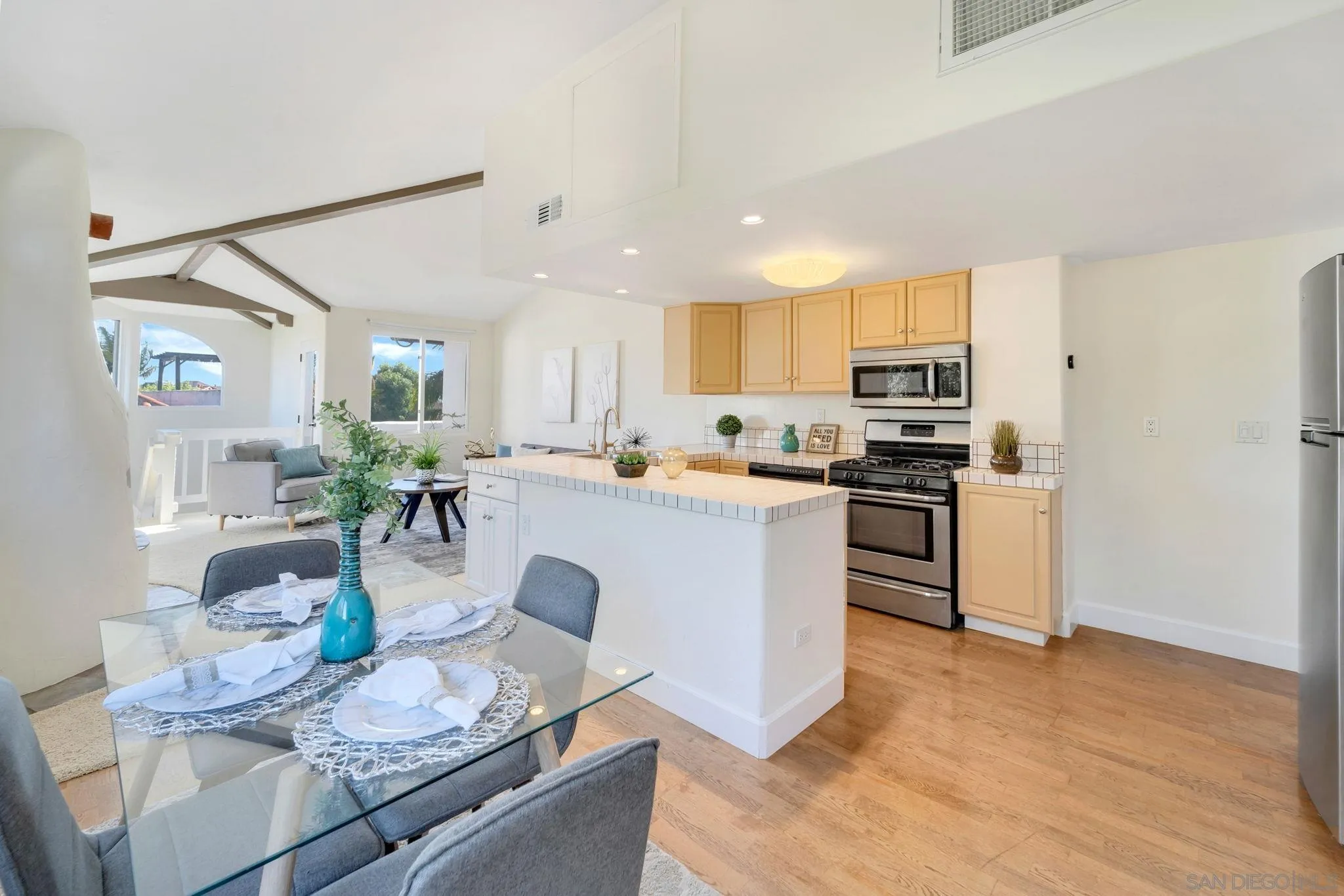 914 Agate Street, Unit E San Diego, CA 92109 - Photo 5 of 24 a living room with stainless steel appliances kitchen island granite countertop a stove a sink a refrigerator and white cabinets