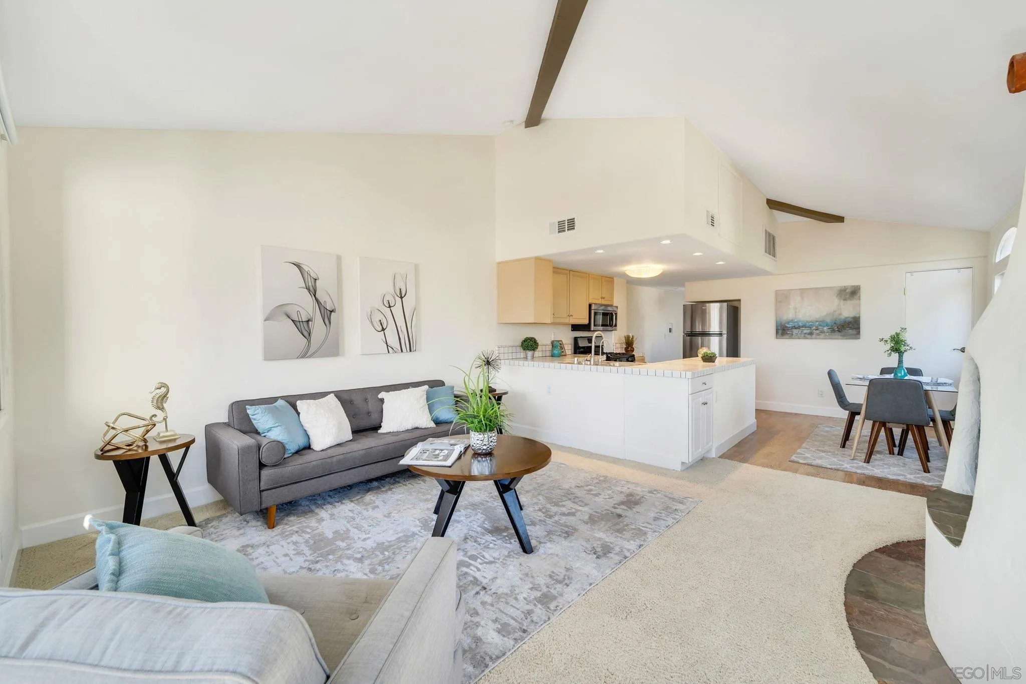 914 Agate Street, Unit E San Diego, CA 92109 - Photo 10 of 24 a living room with furniture and a dining table with rug