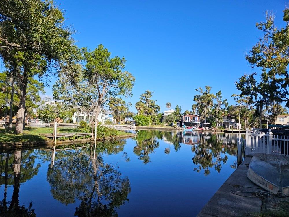 a view of a lake with couches and city view