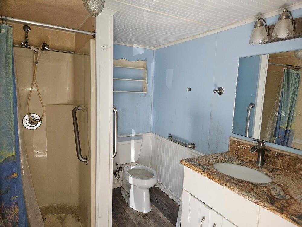 5281 Tuna Lane Weeki Wachee, FL 34607 - Photo 14 of 16 a bathroom with a granite countertop sink toilet and shower