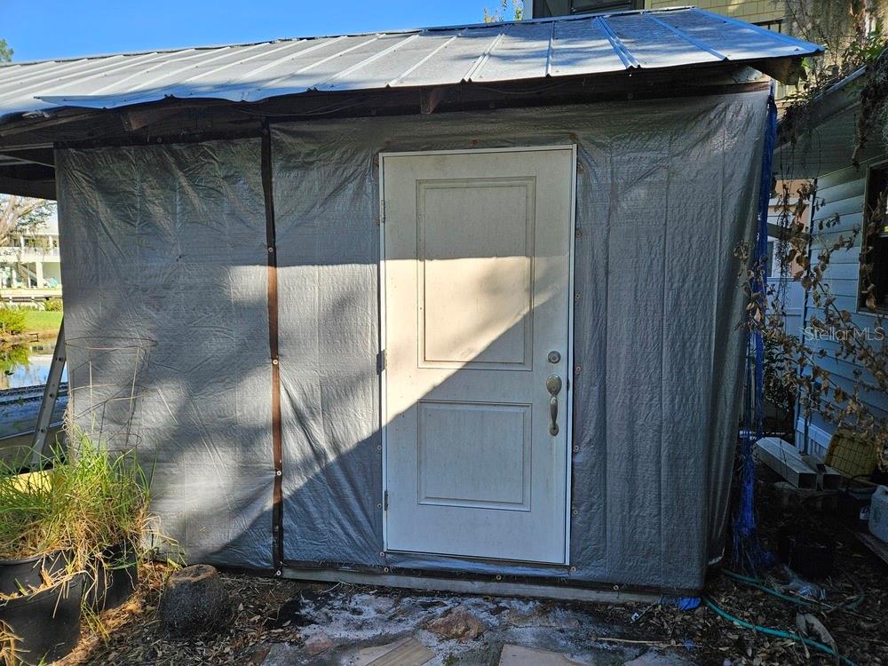 5281 Tuna Lane Weeki Wachee, FL 34607 - Photo 16 of 16 a side view of a house with a wooden bench