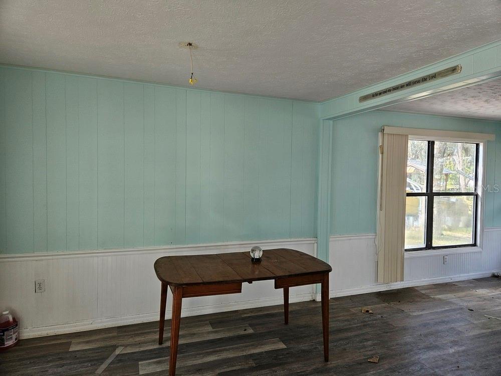 5281 Tuna Lane Weeki Wachee, FL 34607 - Photo 9 of 16 a view of a room with wooden floor and a window