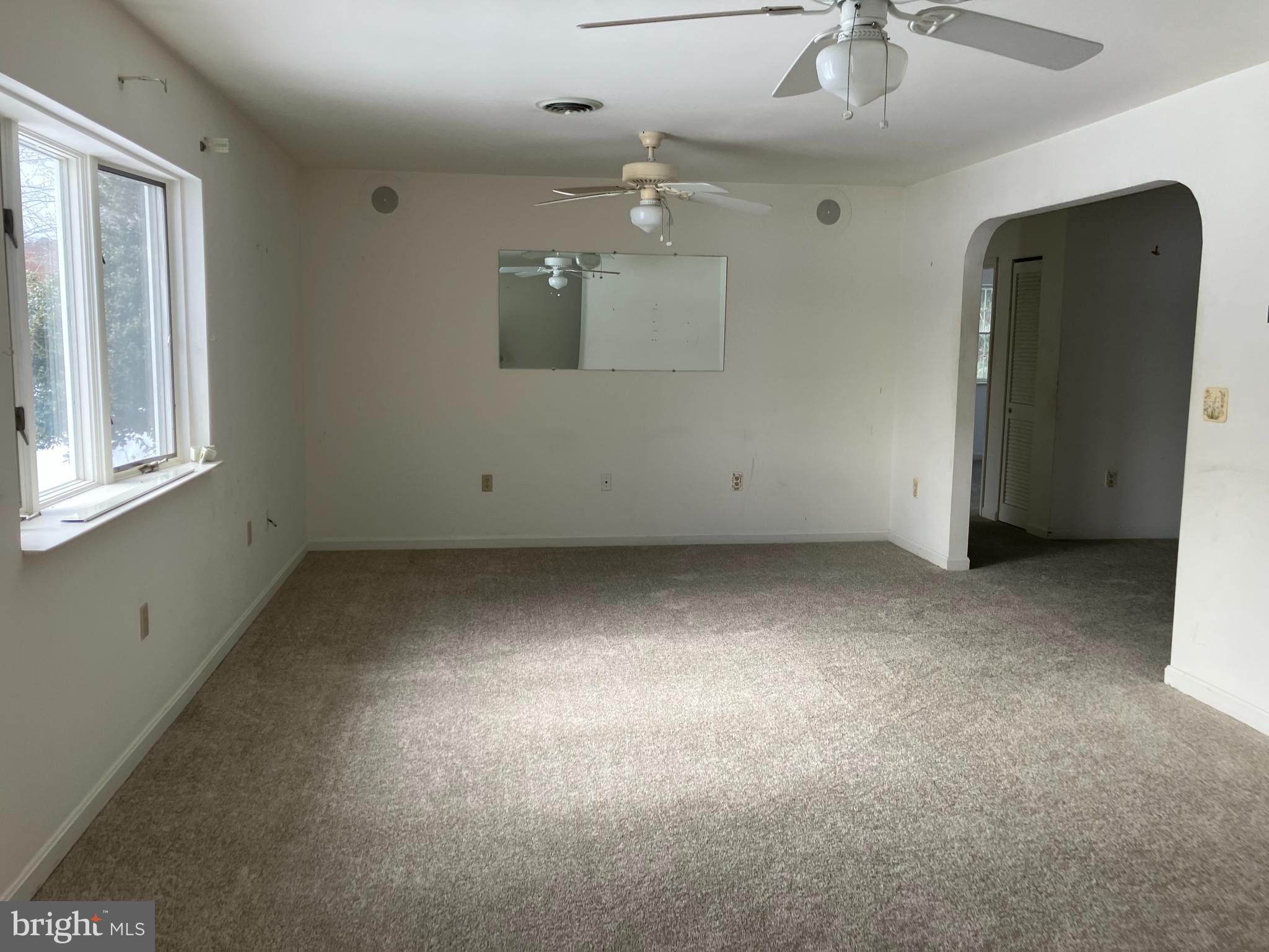 21336 Haven Road Rock Hall, MD 21661 - Photo 7 of 29 en empty room with windows and ceiling fan