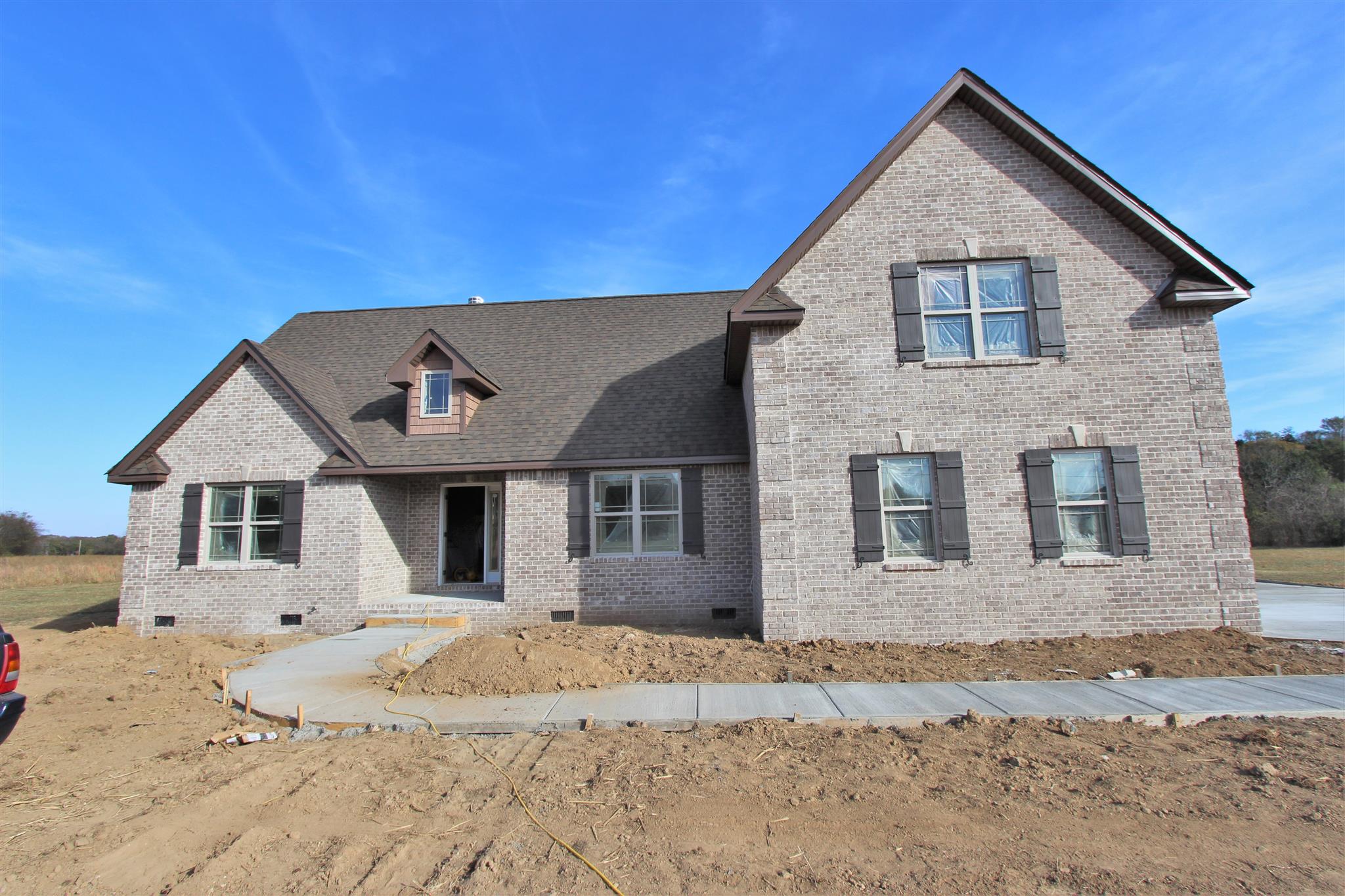 400 Beech Log Road Watertown, TN 37184 - Photo 2 of 22 a front view of a house with a dirt yard and a large tree