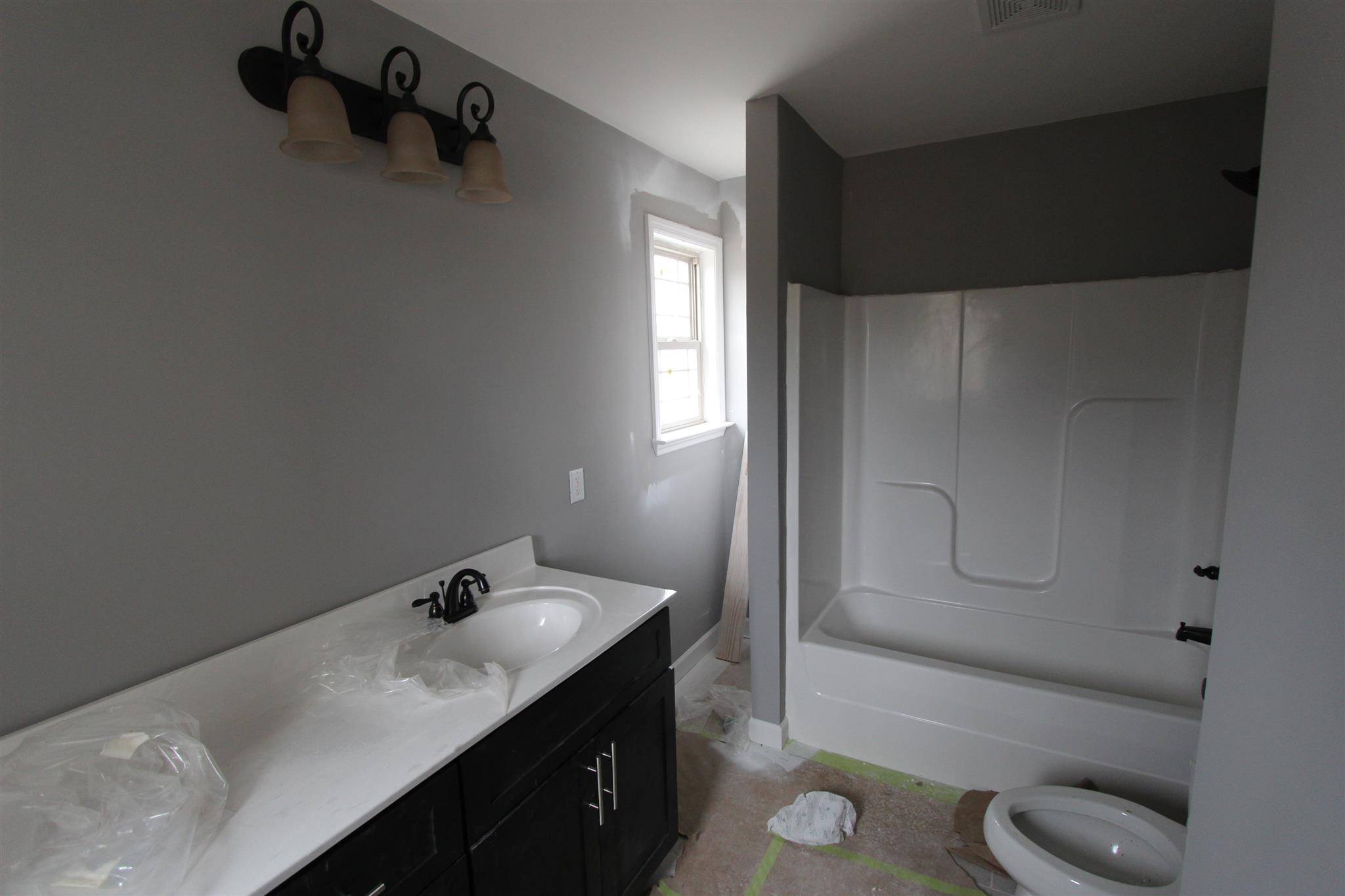 400 Beech Log Road Watertown, TN 37184 - Photo 19 of 22 a bathroom with a granite countertop sink toilet and bathtub