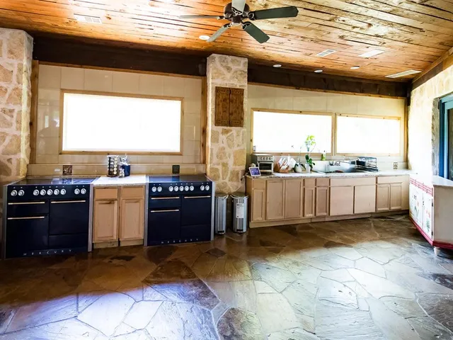 a kitchen with a stove a sink and a microwave