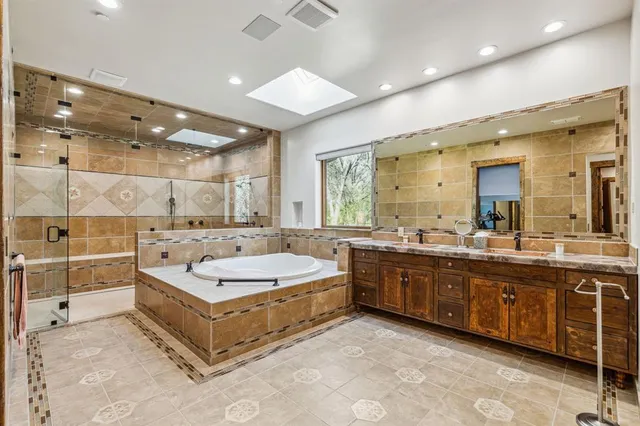 a large bathroom with a large tub sink and double vanity