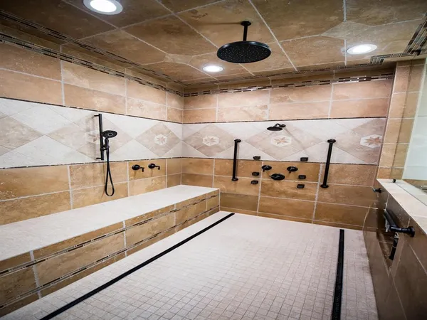 a large kitchen with stainless steel appliances kitchen island granite countertop a sink and a refrigerator