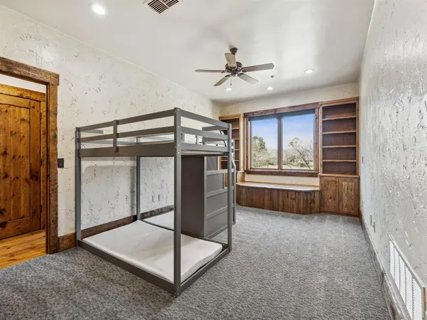 a bedroom with a bed and a window