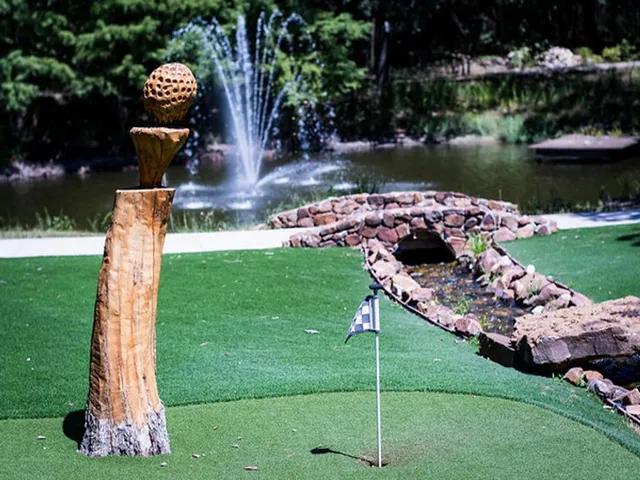 a view of a patio with table and chairs potted plants with large tree