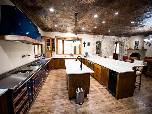 a large kitchen with lots of counter space and stainless steel appliances